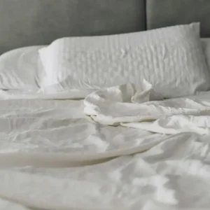 How to soften linen sheets with naturally relaxed white linen bedding on a cozy bed