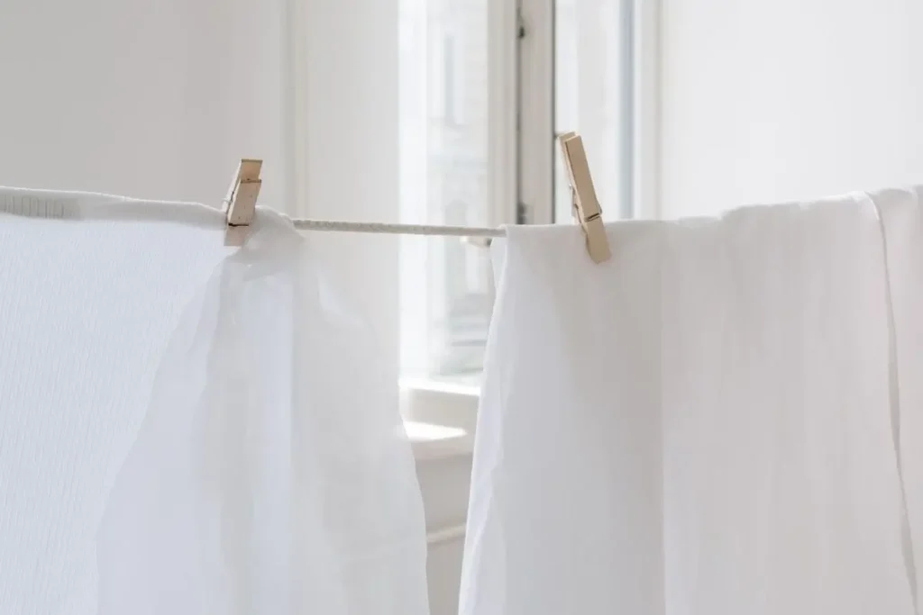 Air drying linen sheets near an open window