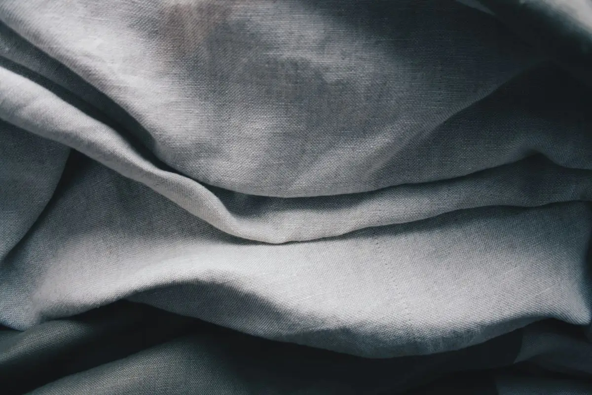 Gray linen sheet with visible natural texture and soft folds