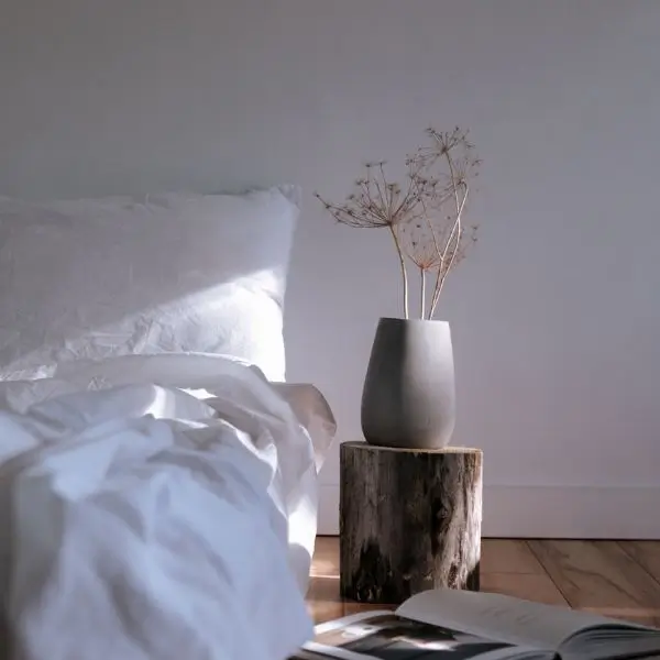 Best natural fabrics for bed sheets in a bright minimalist bedroom.
